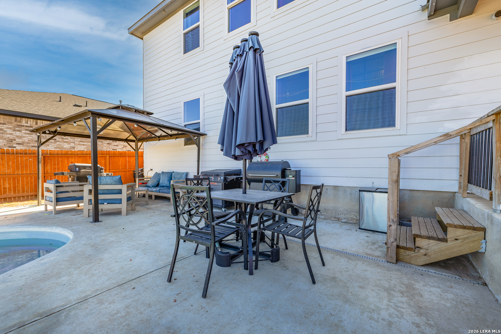 229 Jereth Crossing Castroville, TX 78009 - Photo 38 of 41 a view of a patio with a table and chairs under an umbrella