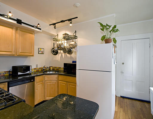 267 Bunker Hill Street Boston, MA 02129 - Photo 6 of 14 a kitchen with a refrigerator a stove a sink and wooden floor