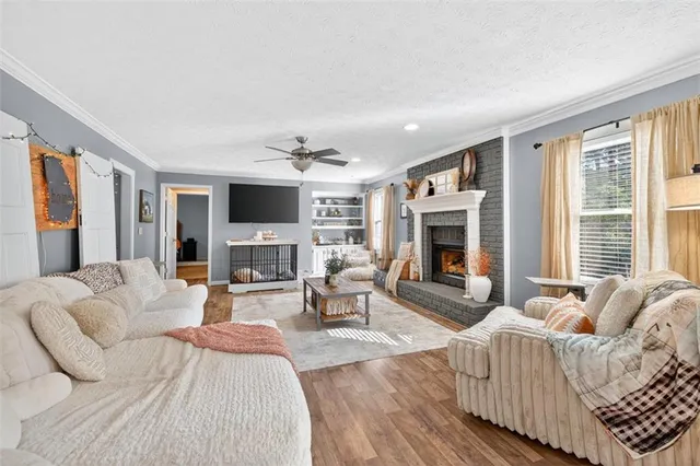 a living room with furniture fireplace and flat screen tv