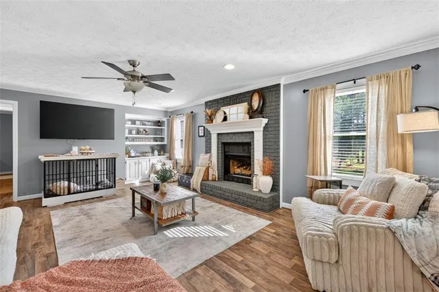 a living room with stainless steel appliances granite countertop furniture and a kitchen view