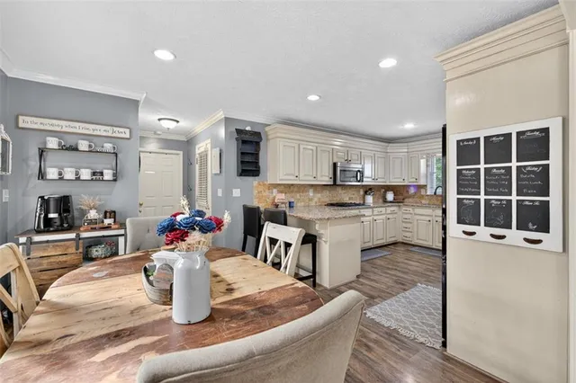 a living room with furniture and a dining table with kitchen view
