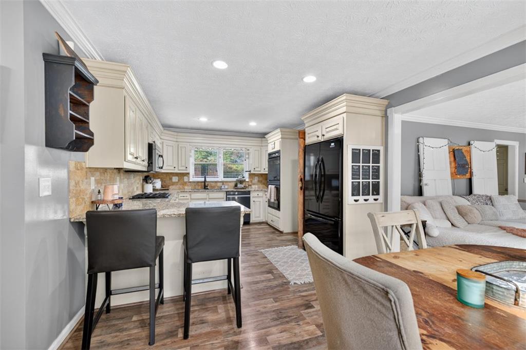 2380 Camp Mitchell Road Grayson, GA 30017 - Photo 17 of 56 a living room with furniture and a dining table with kitchen view
