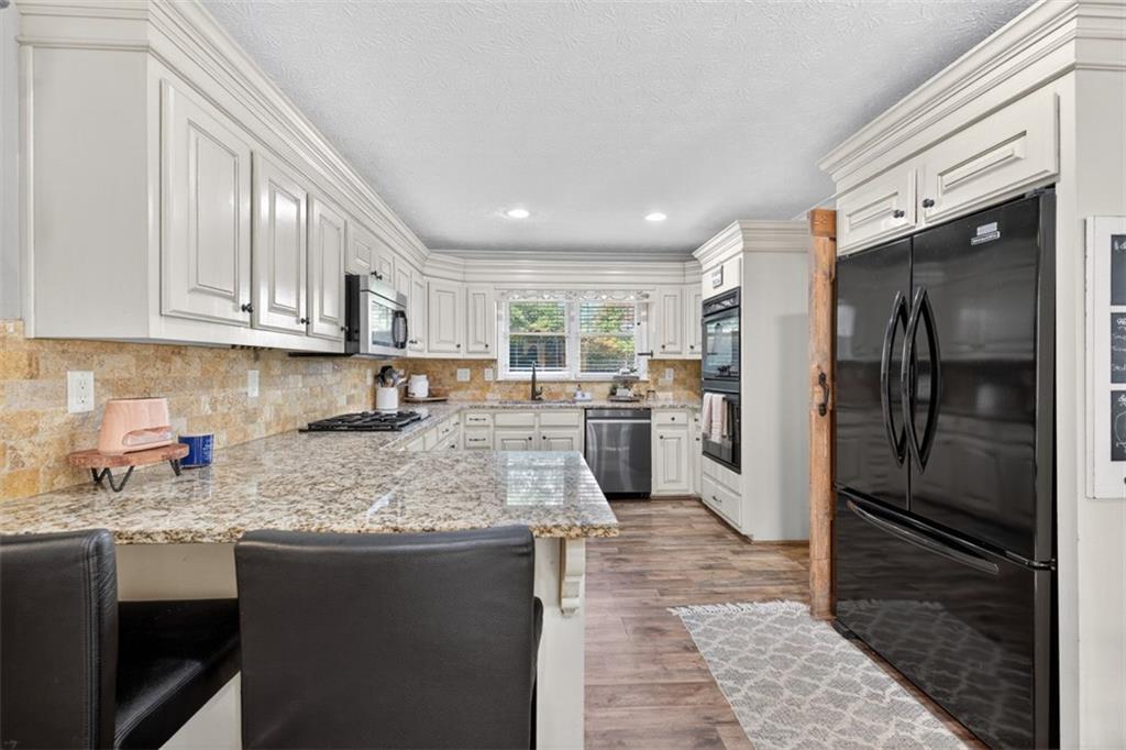 2380 Camp Mitchell Road Grayson, GA 30017 - Photo 18 of 56 a kitchen with stainless steel appliances granite countertop a refrigerator a sink a stove and oven