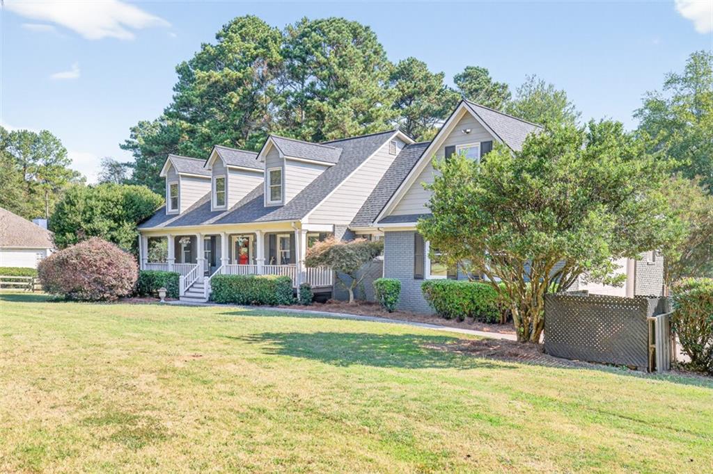 2380 Camp Mitchell Road Grayson, GA 30017 - Photo 2 of 56 a view of a house with a yard and potted plants