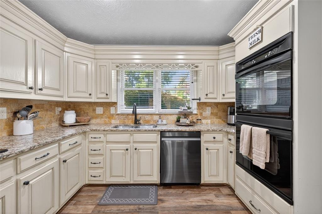 2380 Camp Mitchell Road Grayson, GA 30017 - Photo 21 of 56 a kitchen with stainless steel appliances granite countertop a stove a sink and a microwave