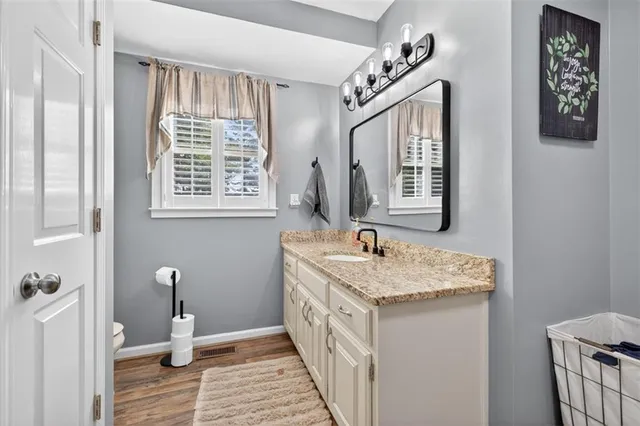 a spacious bedroom with a bed and a chandelier