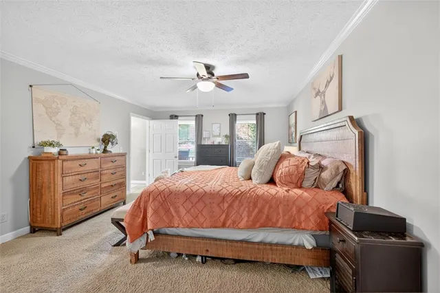a spacious bedroom with a bed and a chandelier