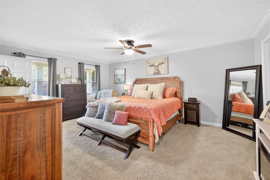 2380 Camp Mitchell Road Grayson, GA 30017 - Photo 27 of 56 a spacious bedroom with a bed and a chandelier