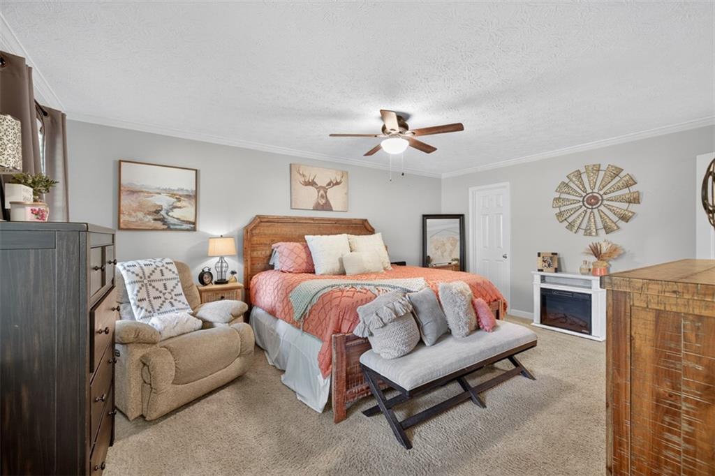 2380 Camp Mitchell Road Grayson, GA 30017 - Photo 28 of 56 a spacious bedroom with a bed and a chandelier