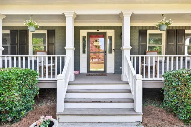 a living room with furniture and a stairs