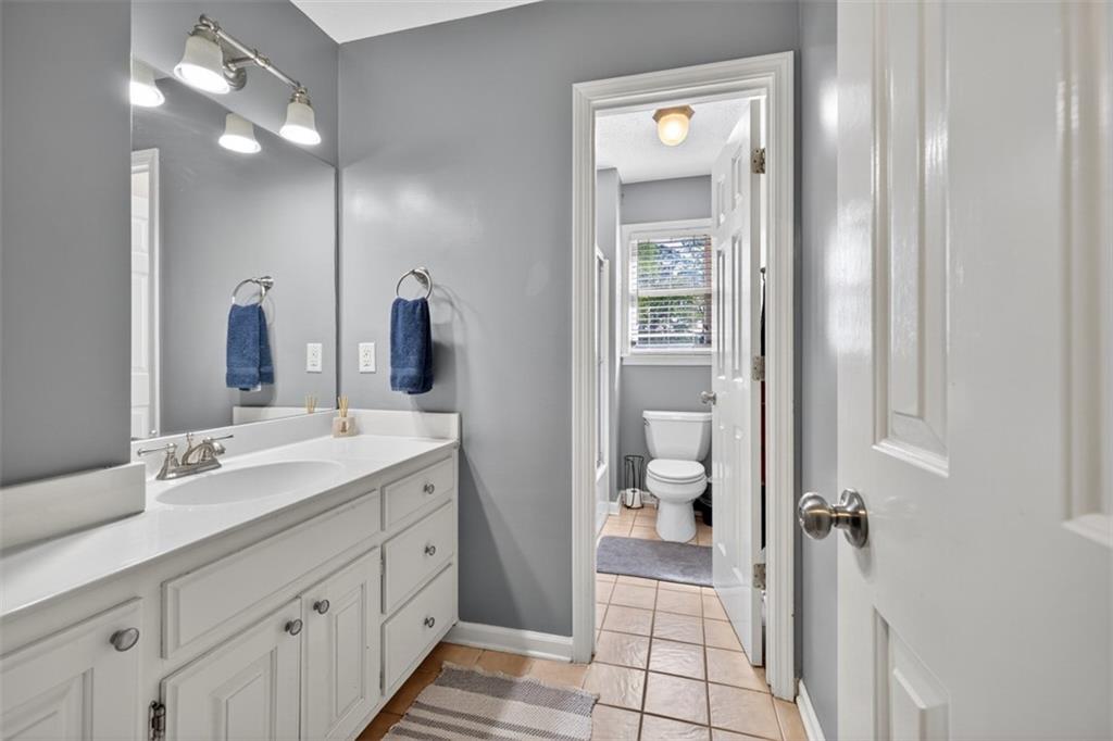 2380 Camp Mitchell Road Grayson, GA 30017 - Photo 31 of 56 a bathroom with a double vanity sink and a mirror