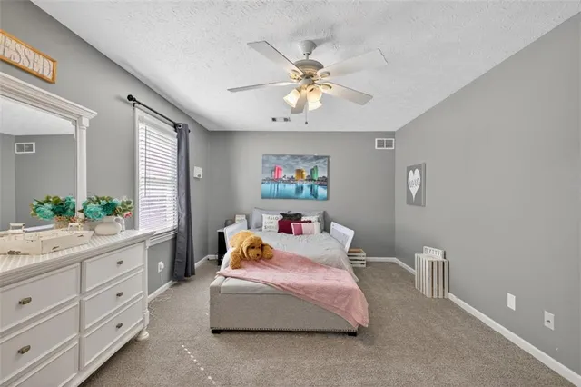 a room with pool table and windows