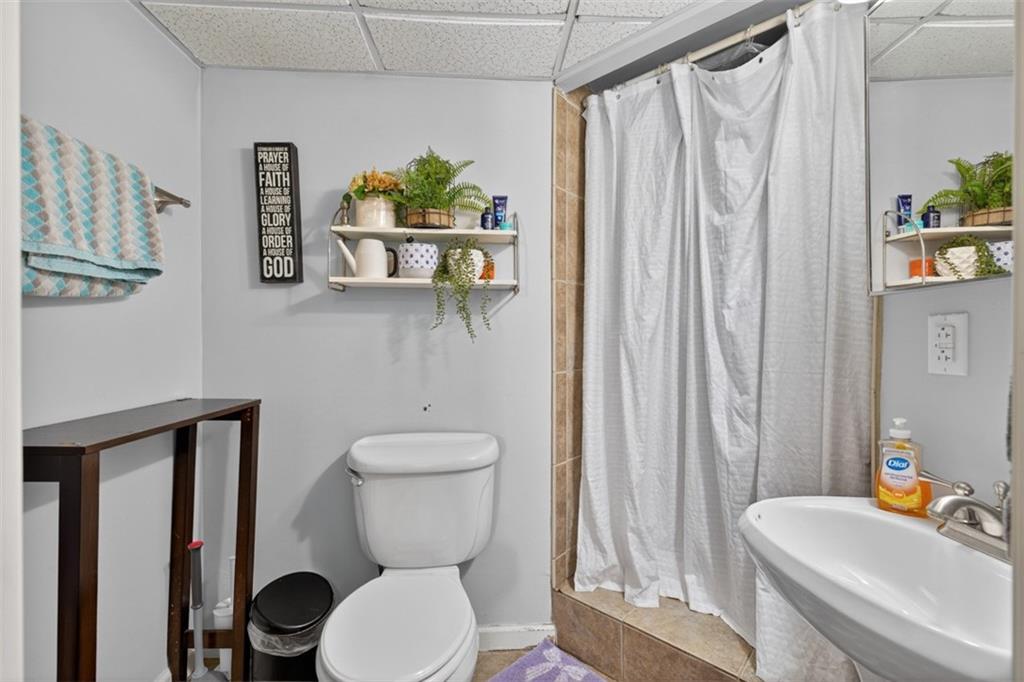 2380 Camp Mitchell Road Grayson, GA 30017 - Photo 40 of 56 a white toilet sitting next to a bathroom sink and tub
