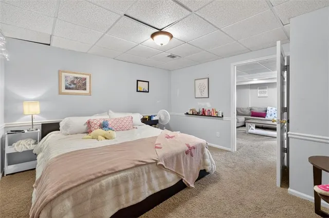a living room with a floor to ceiling window and couch