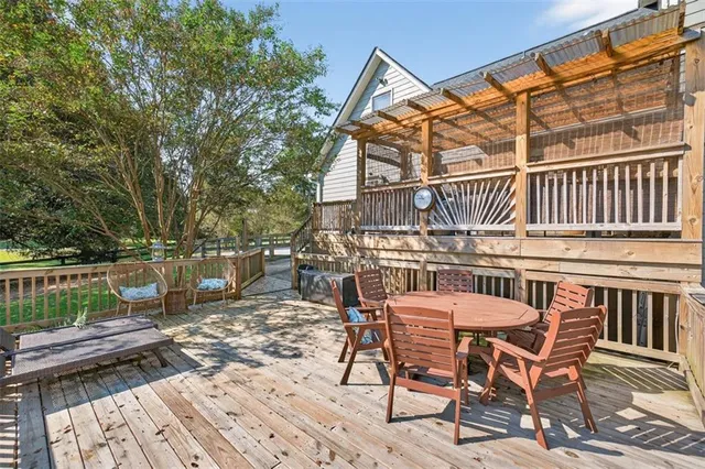 a view of a house with backyard and sitting area