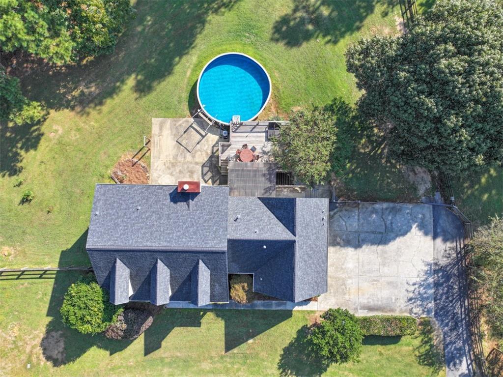 2380 Camp Mitchell Road Grayson, GA 30017 - Photo 51 of 56 an aerial view of a house with swimming pool and large trees