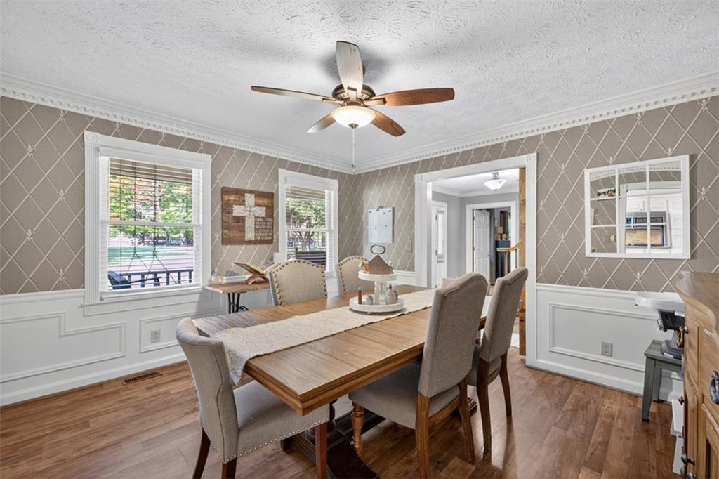 2380 Camp Mitchell Road Grayson, GA 30017 - Photo 7 of 56 a dining room with furniture a chandelier and wooden floor