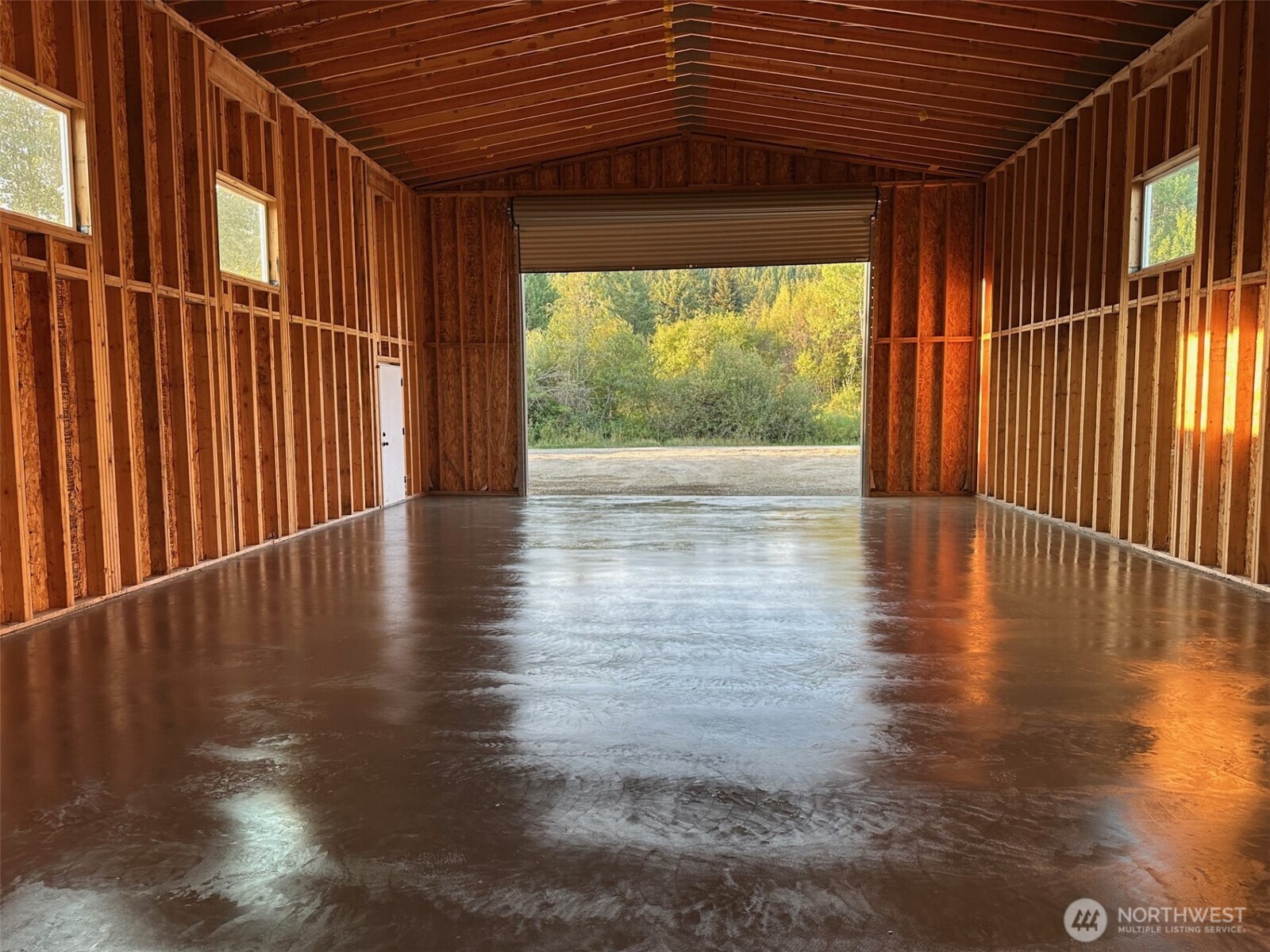 521 3 Lakes Road Cle Elum, WA 98922 - Photo 3 of 9 an empty room with wooden floor and windows