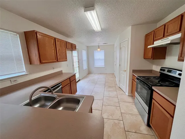 a kitchen that has a sink and a stove