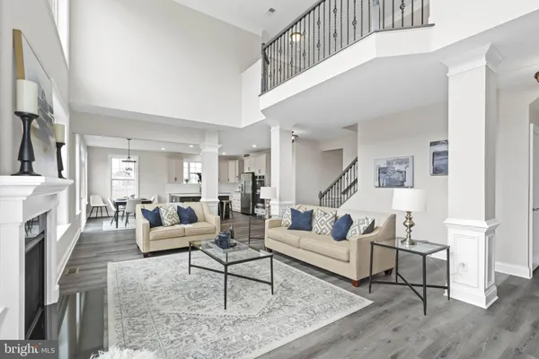 a living room with fireplace furniture and a wooden floor
