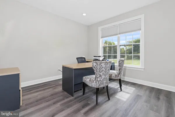 a dining room with furniture and wooden floor