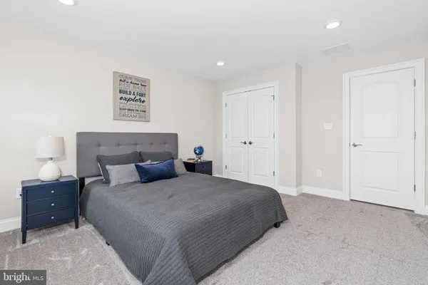 a bedroom with a bed and a couch