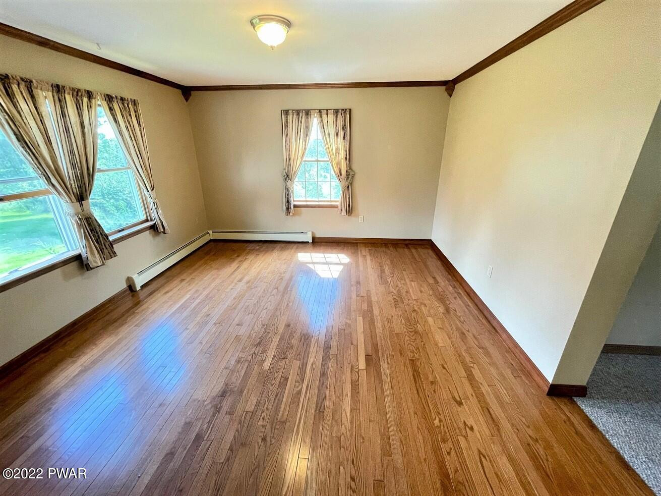 524 Creamton Drive Prompton, PA 18456 - Photo 15 of 57 a view of an empty room with wooden floor and a window