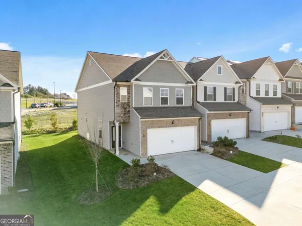 a front view of a house with a garden