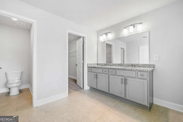 a bathroom with a tub sink shower and mirror