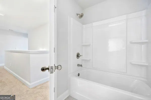 an empty room with closet and a bathroom