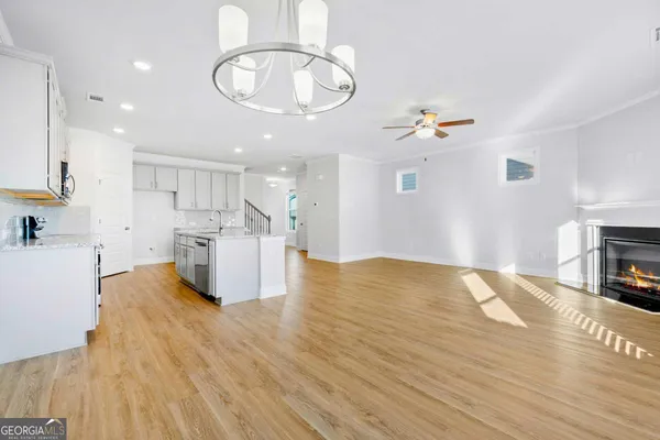 a view of kitchen and hall with wooden floor