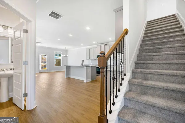 a view of entryway and hall with wooden floor