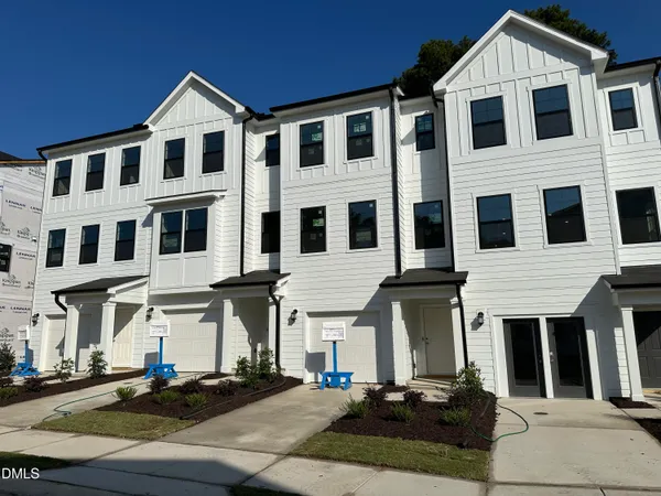 a front view of a residential apartment building with parking space
