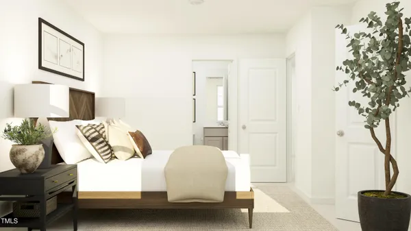 a bedroom with a bed and a potted plant