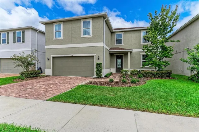 a front view of a house with a garden and plants