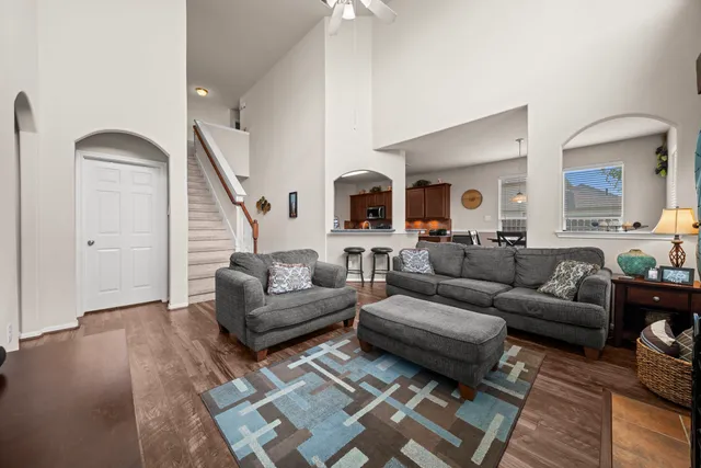 a living room with furniture and a wooden floor