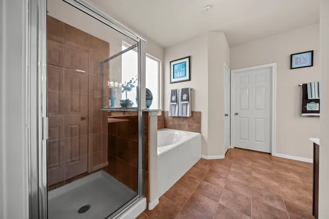 a spacious bathroom with a bathtub and a shower