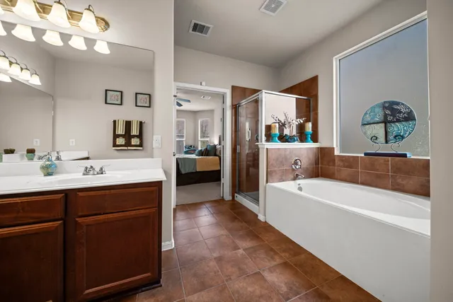 a bathroom with a tub a sink and a mirror