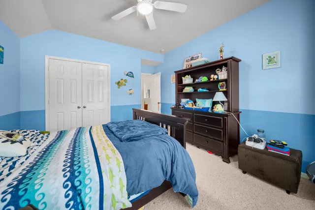 a bedroom with a bed and dresser