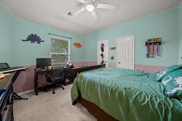 a bedroom with a bed and a desk