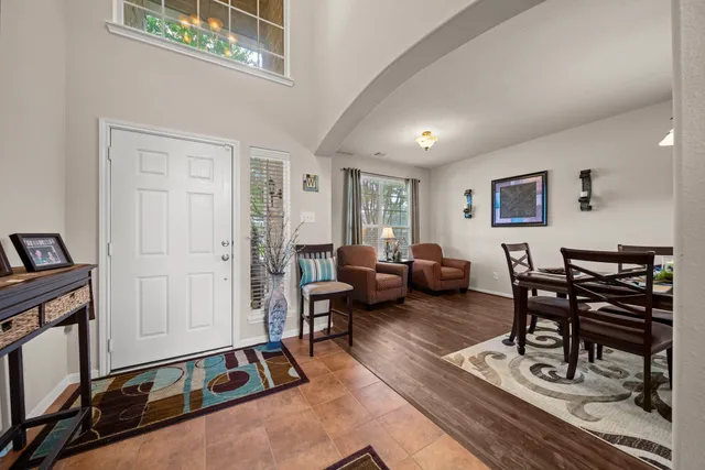 a living room with furniture a wooden floor and a flat screen tv