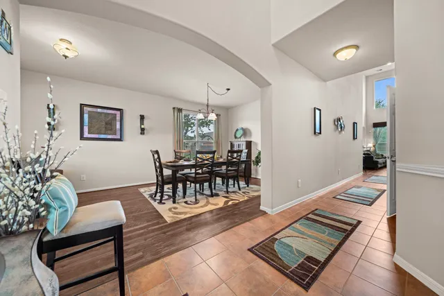 a living room with furniture and a dining table