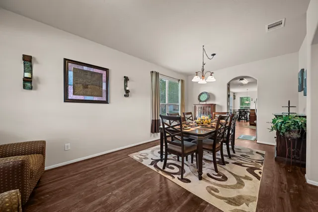a view of a dining room with furniture and wooden floor
