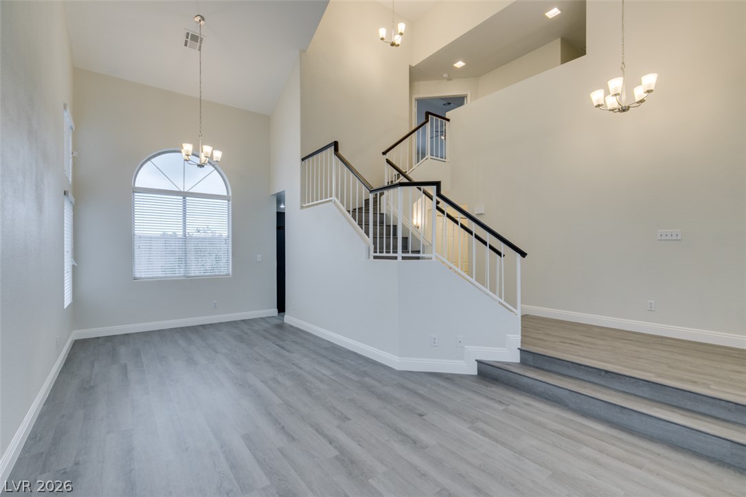 1738 Toltec Circle Henderson, NV 89014 - Photo 22 of 46 A spacious entry showcases soaring vaulted ceilings and a grand split-level staircase, creating an airy welcome.