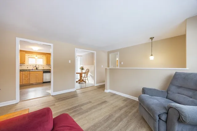 a living room with furniture and kitchen view