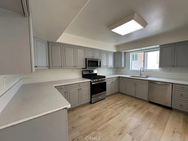 a kitchen with stainless steel appliances and white cabinets
