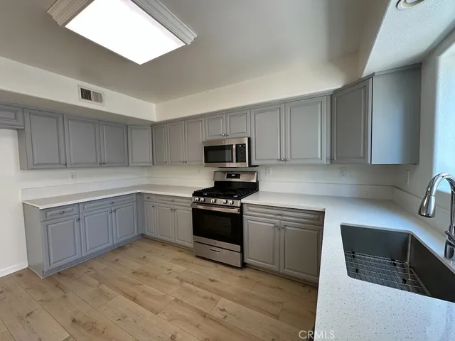 a view of kitchen with microwave and wooden floor