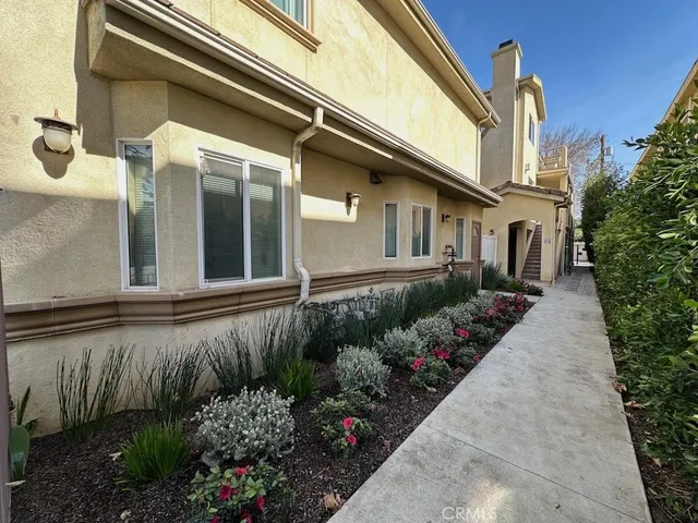 a view of a house with a flower garden