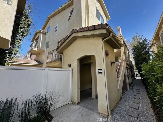 a front view of a house with plants