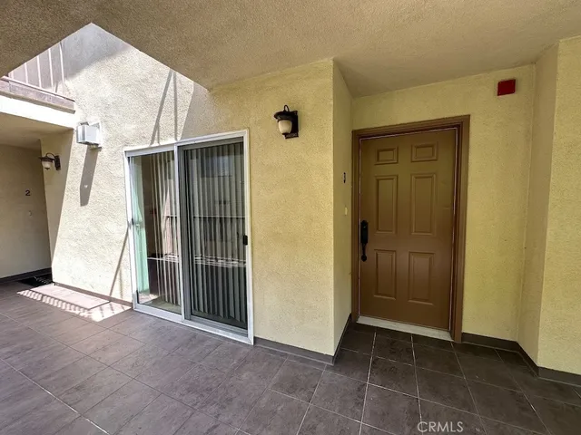 an empty room with wooden floor and a fireplace
